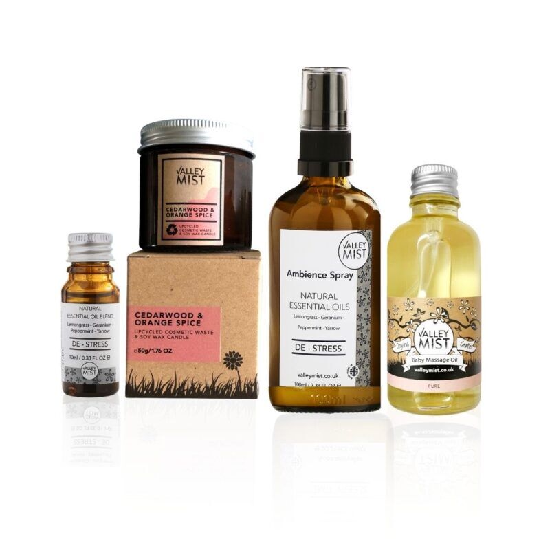 Couples ritual gift set with aromatherapy spray, essential oils, fragrance-free massage oil and candle arranged for a calm evening at home.